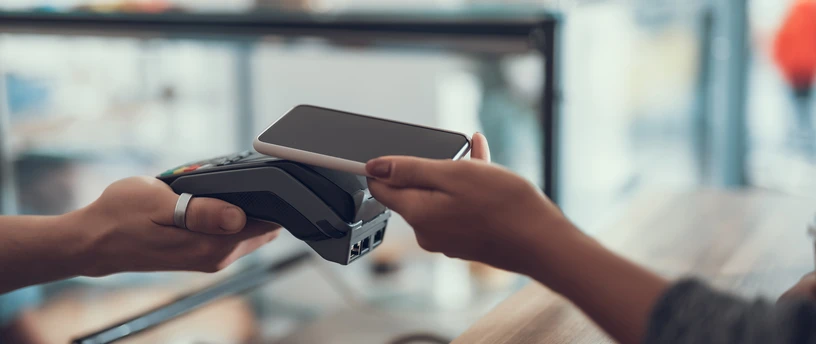 Person betaler med smartphone i butik